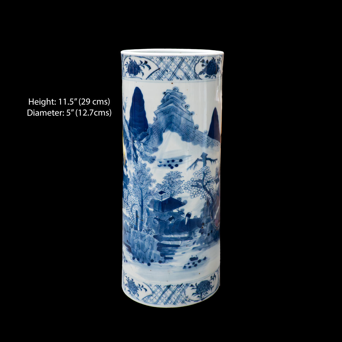 A product reference image of a 19th-century Chinese blue and white porcelain cylindrical hat stand on a black background. Overlay text on the left reads: Height: 11.5 inches (29 cms), Diameter: 5 inches (12.7 cms). The hand-painted scene on the vase displays towering mountain peaks, houses, and trees.