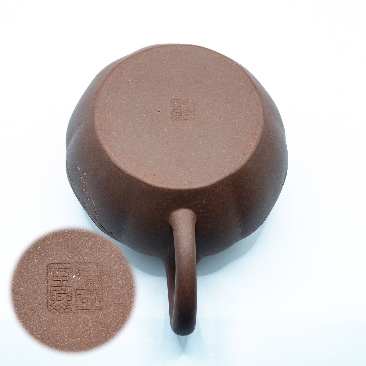 Macro view of the base of a vintage Factory 1 Yixing teapot showing the authentic four-character Zhongguo Yixing square mark with a magnified inset circle.