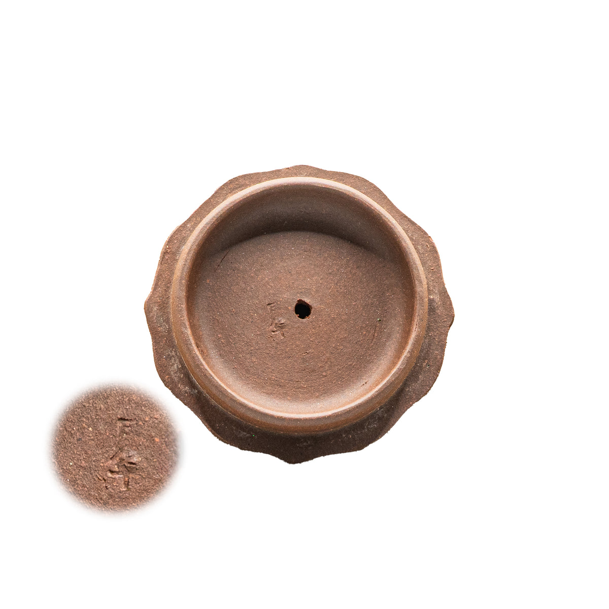 Macro view of the underside of a vintage Factory 1 Yixing teapot lid showing the authentic hand-stamped Chinese artisan seal characters for Yue hua.