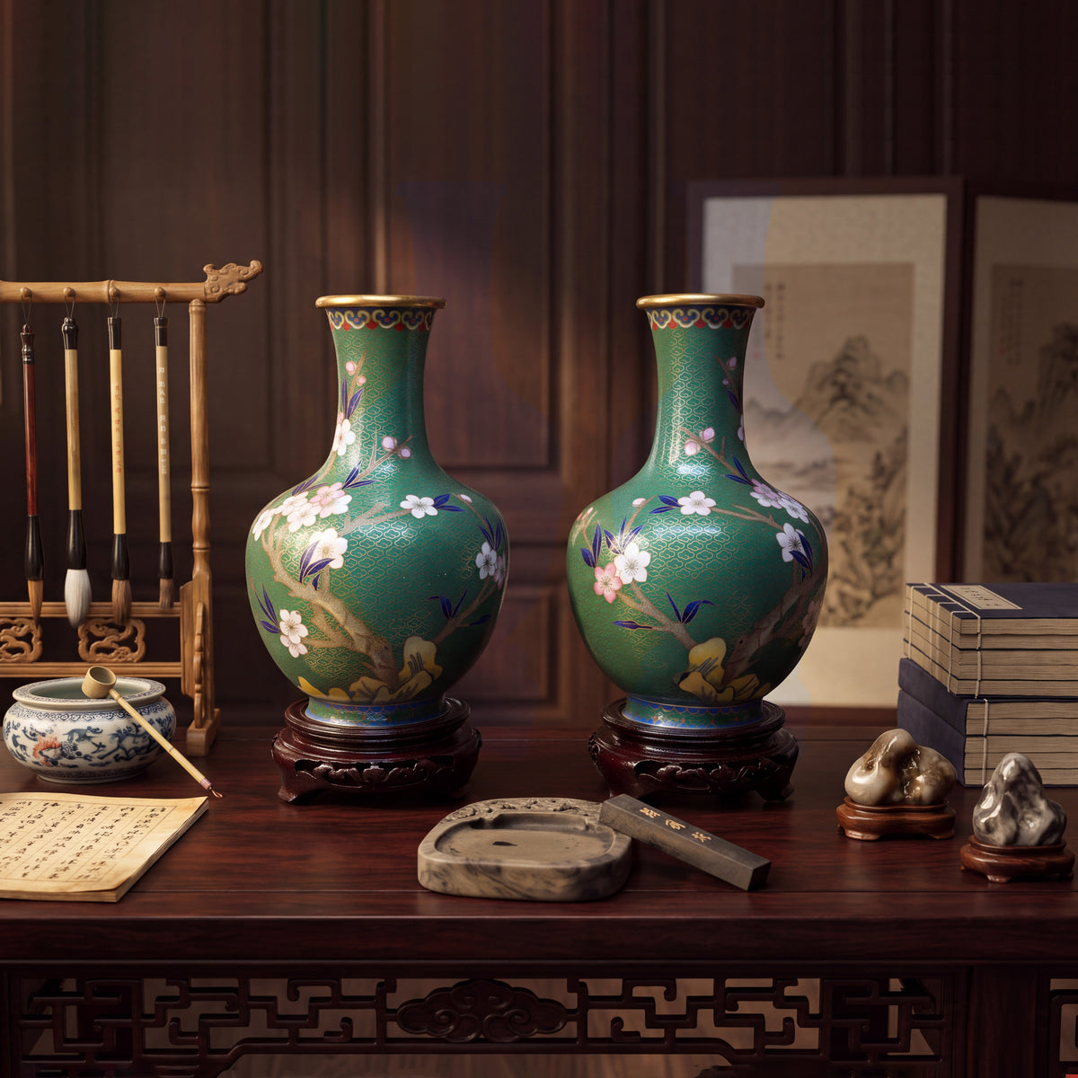 Chinese cloisonne enamel green baluster vases displayed in a traditional scholar's study environment, featuring writing brushes hanging on a wooden rack, ink stones, and mountain viewing stones.