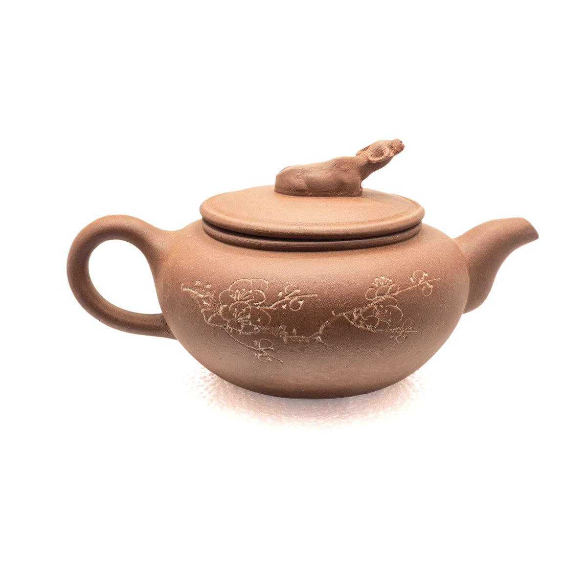 Reverse view of vintage Factory 1 Yixing Zisha teapot showing a hand-engraved plum blossom branch motif and a sculpted water buffalo lid finial.