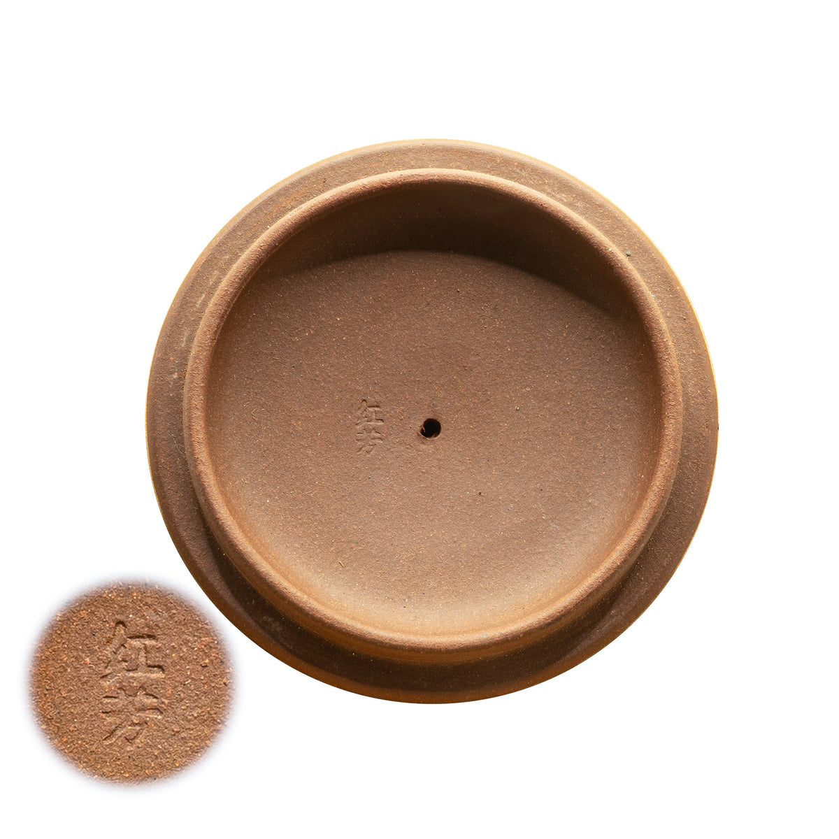 Macro view of the underside of a vintage Factory 1 Yixing teapot lid showing the authentic hand-stamped Chinese artisan seal characters for Hongxiu.